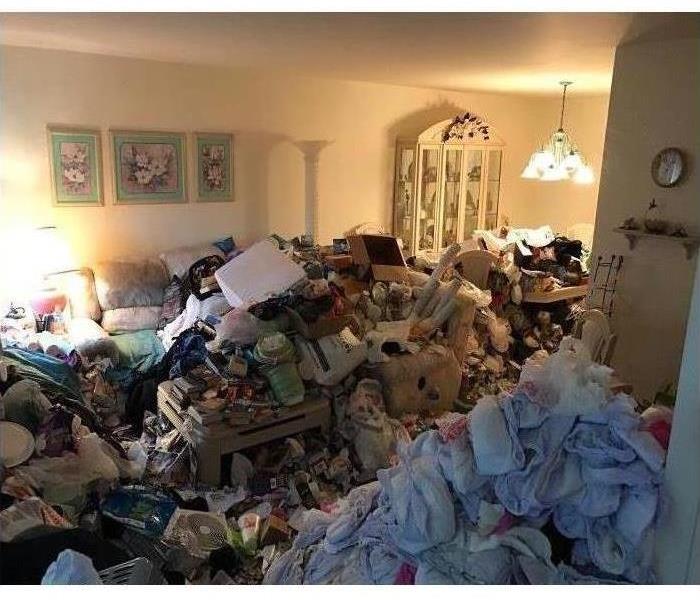 Contents and trash piled up in a living room