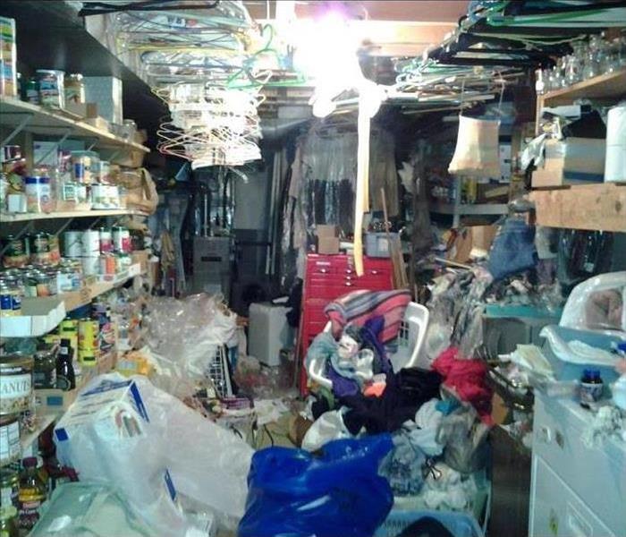 Basement filled with contents from floor to ceiling exposed to water